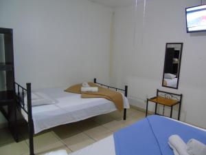 Ein Bett oder Betten in einem Zimmer der Unterkunft Hotel Quinta Avenida