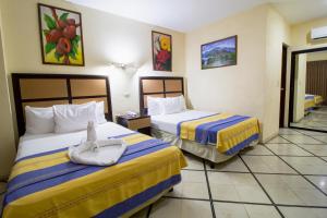 Postel nebo postele na pokoji v ubytování Hotel Ambassador Mérida + 37 fotografií