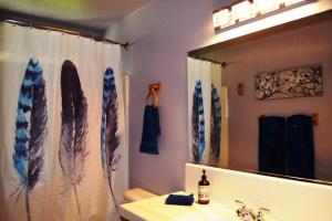 a bathroom with a sink and a mirror with surfboards at Blue Jay Paradise in Three Rivers +19 photos