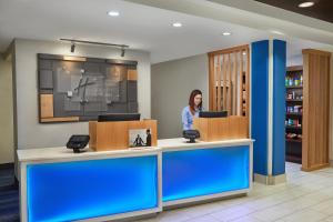 a woman standing at a counter in a hospital lobby at Holiday Inn Express Hotel & Suites Pensacola-West Navy Base, an IHG Hotel in Pensacola