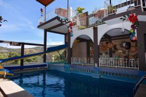 a pool at a resort with a slide at Hotel Yara in Ixtapan de la Sal