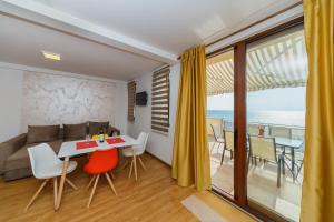 a living room with a table and chairs and a couch at Vila Fortuna in Sutomore