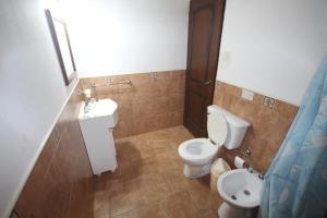 a bathroom with a toilet and a sink at Aires del Ibera in Colonia Carlos Pellegrini +23 photos