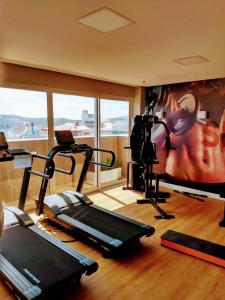 a gym with several tread machines and a large window at Flat em Cabo Frio in Cabo Frio