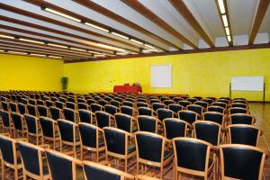an empty lecture hall with chairs and a podium at Park Hotel Jolanda in San Zeno di Montagna +71 photos