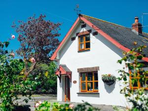 a white house with a red roof at Barn Cottage in Spittal