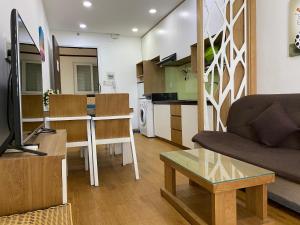 a living room with a couch and a table at Gold Ocean Apartment in Nha Trang