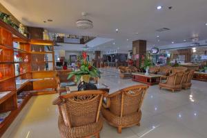 a restaurant with wicker chairs and tables in a store at Hotel Essencia- Multiple Use Hotel in Dumaguete