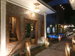 a brick house with a patio at night at Tam Coc Marina villa in Ninh Binh
