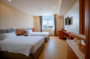 Postel nebo postele na pokoji v ubytování Bella Vita Hotel