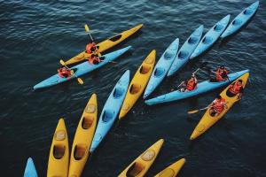 a group of people in kayaks in the water at LaPinta Boutique Cruises in Ha Long