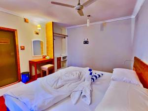 Voodi või voodid majutusasutuse Ocean Way Guraidhoo toas