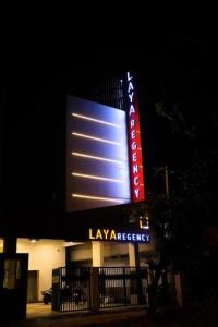 a large lit up sign in front of a building at Laya Regency in Mayiladuthurai