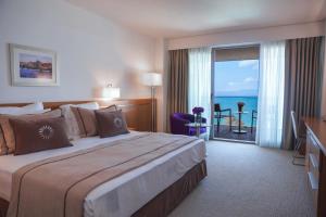a hotel room with a bed with a view of the ocean at ON'LIVE HOTEL in Çeşme