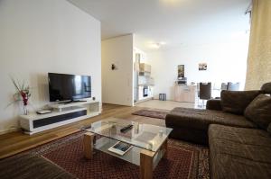 a living room with a couch and a tv at · High-Quality in the heart of Stuttgart 3 in Stuttgart