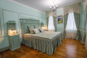 a bedroom with a bed and two windows at Гостевой дом-музей Красовских in Kirzhach