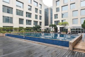 
a large building with a pool of water in front of it at Holiday Inn New Delhi International Airport, an IHG Hotel in New Delhi
