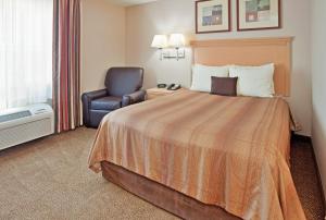 A bed or beds in a room at Candlewood Suites Junction City - Ft. Riley, an IHG Hotel