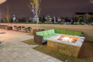 a green couch sitting on a patio with a fire pit at Holiday Inn Trophy Club, an IHG Hotel in Trophy Club
