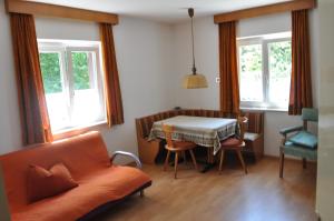 a living room with a table and a couch at Haus Sabina in Siusi