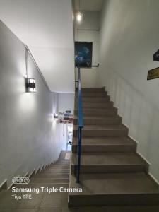 a staircase in a building with a blue at De Chukai Hotel in Kampong Kemaman