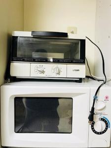 a microwave sitting on top of a microwave oven at Dotonbori Condo♡Shinsaibashi 302 (100-3) in Osaka