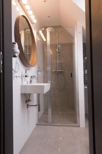 a bathroom with a shower and a sink and a mirror at Studio Jaworzyna in Krynica Zdrój