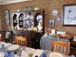 a dining room with blue and white plates on a table at Amzee Bokmakierie Guest House in Dana Bay