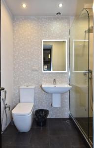 a bathroom with a toilet and a sink and a shower at Freedom Apartment on Nalbandyan street in Yerevan