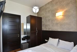 a bedroom with a bed with a wooden headboard at Freedom Apartment on Nalbandyan street in Yerevan