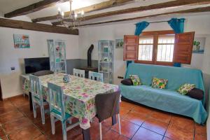 a living room with a table and a couch at Masia Tona in L'Ampolla