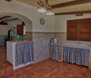 a kitchen with a sink and a counter top at Masia Tona in L'Ampolla