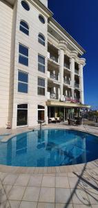 a large building with a swimming pool in front of it at Hotel La Gradisca in Rimini