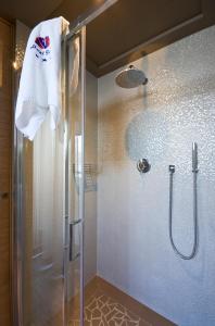a bathroom with a shower with a glass door at Hotel Italia in Bellaria-Igea Marina
