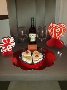 a table with two glasses and a bottle of wine at Wellness Home Rome in Rome