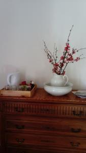 a wooden dresser with a vase on top of it at B and B Sycomore, La Bouriotte in Labastide-Rouairoux