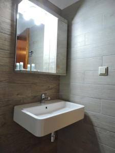 La salle de bains est pourvue d'un lavabo blanc et d'un miroir. dans l'établissement Pandora Studios, à Kala Nera