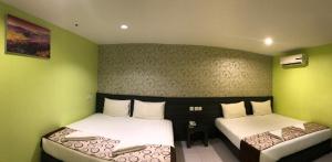 SARIKEI GARDEN HOTEL客房内的一张或多张床位
