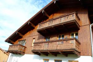 a building with wooden balconies on the side of it at Saliterhof in Warngau