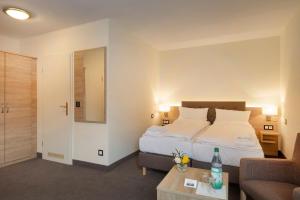 pokój hotelowy z łóżkiem i kanapą w obiekcie Hotel Prinz Albrecht w mieście Neuzelle