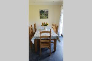 a dining room with a table and chairs at The Curling Pond, Dalmally Road, Inveraray in Inveraray