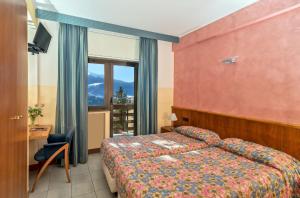a hotel room with a bed and a window at Cipriani Park Hotel in Rivisondoli +124 photos