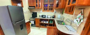 a kitchen with a refrigerator and a counter top at Cape of Goodhope Vacation Home in Arusha