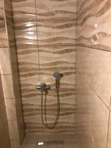 a shower with a hose in a bathroom at Nitsa Rooms in Kos Town