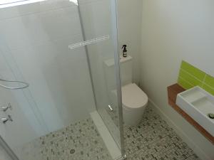 a bathroom with a shower and a toilet and a sink at Wahgunyah Motel in Wahgunyah