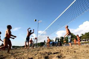 a group of men playing a game of volley ball on the beach at Hotel Istra Plava Laguna in Poreč