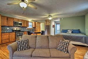 a living room with a couch and a bed at Stockton Lake Escape with Kitchen, Half Mile to Lake in Stockton