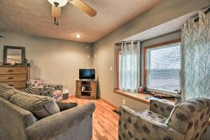 a living room with a couch and chairs and a tv at Stockton Lake Escape with Kitchen, Half Mile to Lake in Stockton