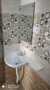 a bathroom with a sink and a mirror at Sar Raj S R RESIDENCY in Vellore