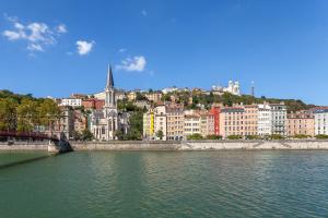 a view of a city with a river and buildings at Le Vieux Lyon charmant et authentique in Lyon